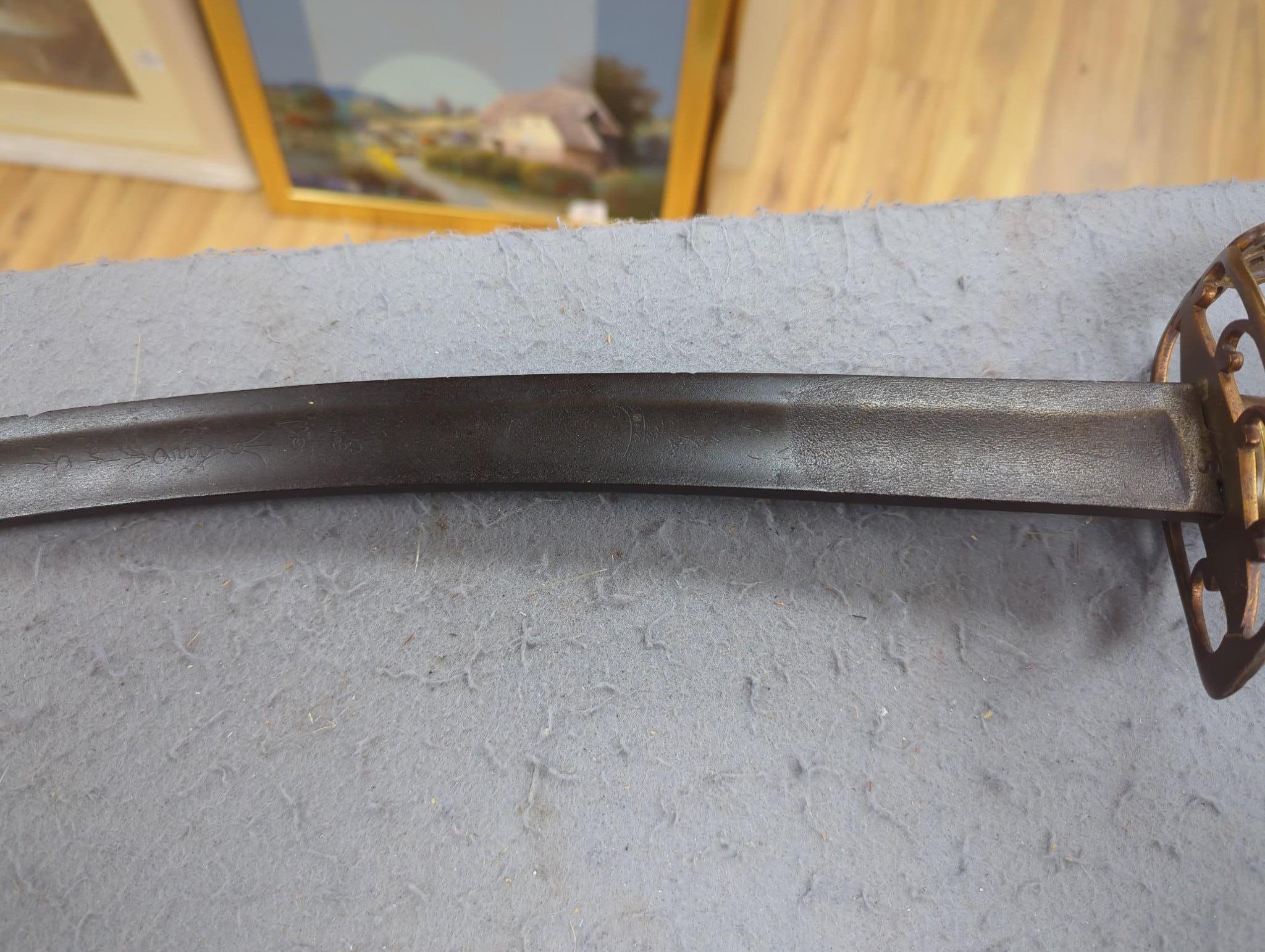 A reproduction cavalry sabre and a bayonet fixing